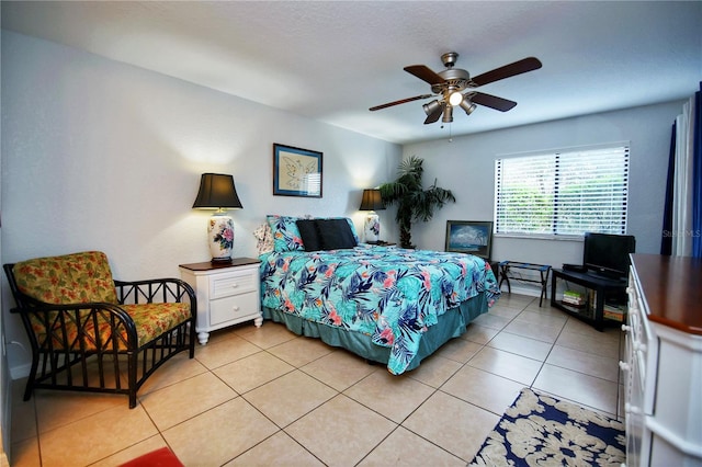 tiled bedroom featuring ceiling fan