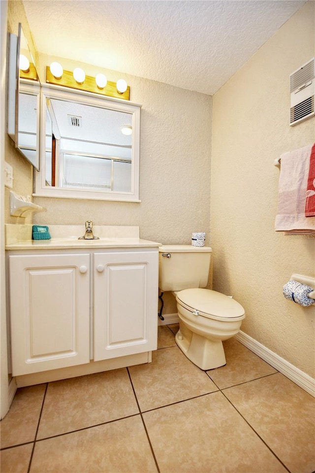 bathroom with toilet, tile floors, a textured ceiling, and vanity