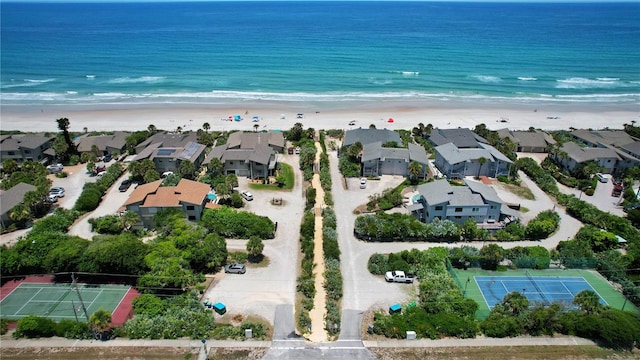 drone / aerial view featuring a beach view and a water view