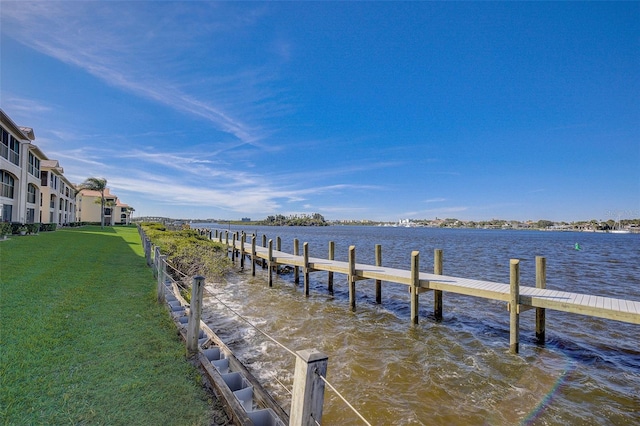 dock area featuring a yard and a water view