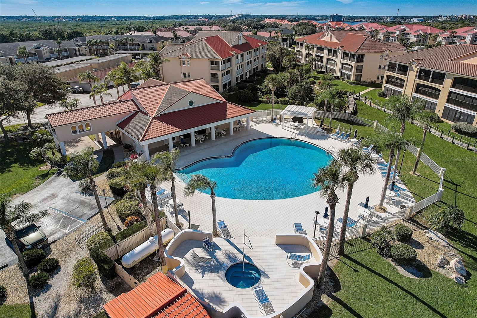 view of pool featuring a yard, a community hot tub, and a patio