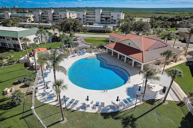 view of swimming pool featuring a lawn and a patio