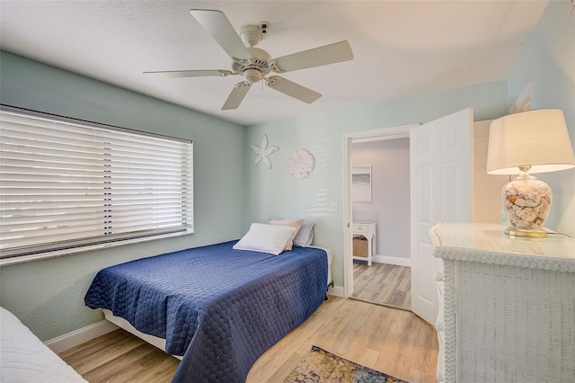 bedroom with ceiling fan and light hardwood / wood-style flooring