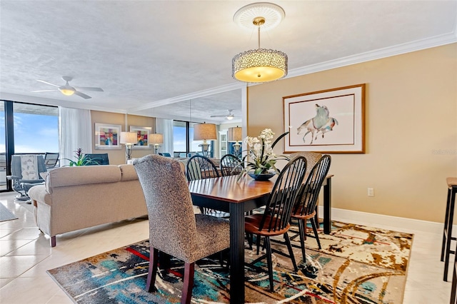 dining room with light tile floors, expansive windows, ceiling fan, a textured ceiling, and ornamental molding