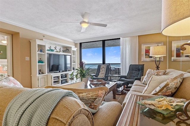 living room featuring a textured ceiling, ceiling fan, and ornamental molding