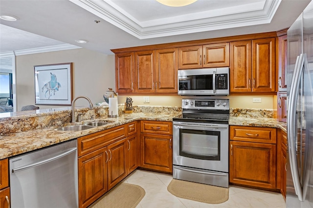kitchen with crown molding, appliances with stainless steel finishes, light stone countertops, and sink