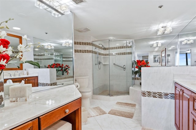 bathroom featuring tile walls, toilet, an enclosed shower, tile floors, and vanity