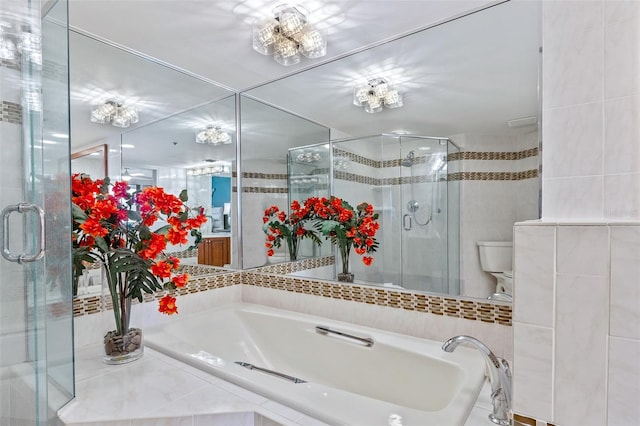 bathroom featuring toilet, separate shower and tub, and tile walls