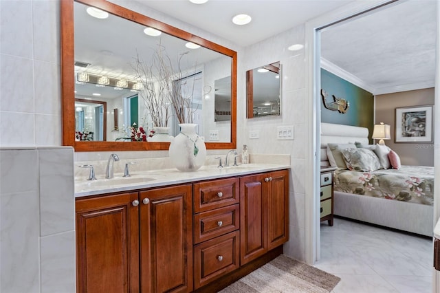 bathroom featuring crown molding, tile walls, double vanity, and tile floors