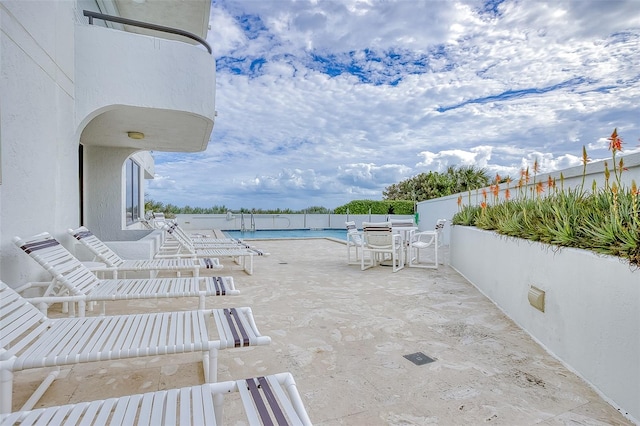 view of terrace featuring a community pool