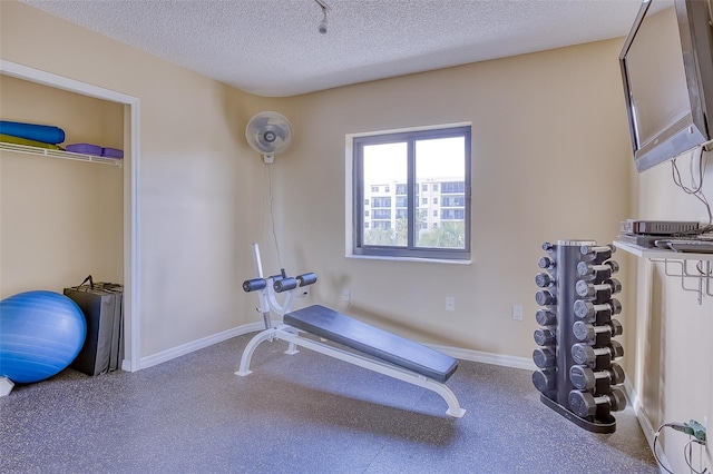 exercise room with a textured ceiling
