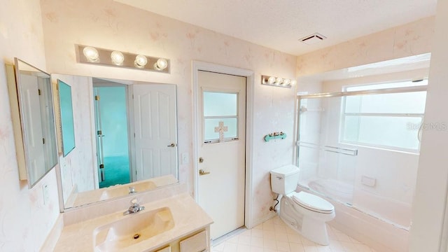 full bathroom with toilet, a healthy amount of sunlight, large vanity, and tile flooring