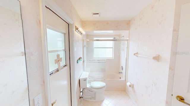 bathroom featuring a textured ceiling, tile floors, shower / washtub combination, and toilet