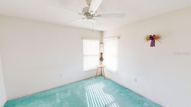 carpeted empty room with a textured ceiling and ceiling fan