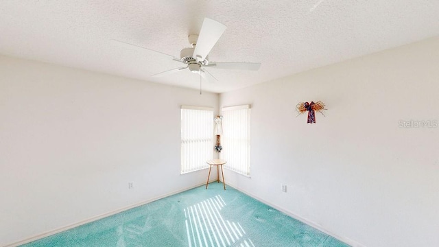 carpeted empty room featuring a textured ceiling and ceiling fan