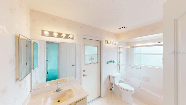 bathroom featuring toilet, tile floors, a textured ceiling, and vanity