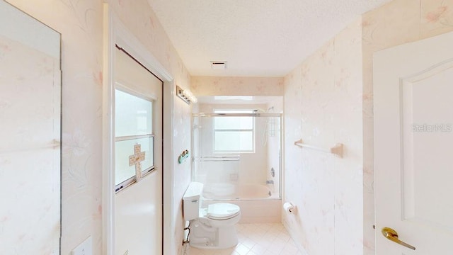 full bathroom with combined bath / shower with glass door, toilet, a textured ceiling, and tile flooring