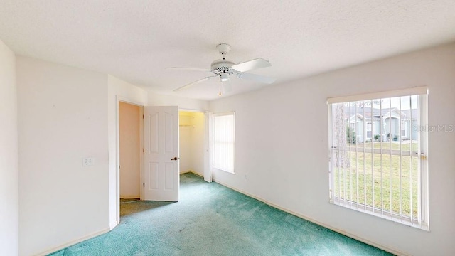 unfurnished bedroom featuring ceiling fan and dark colored carpet