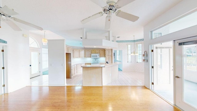 kitchen featuring light tile floors, hanging light fixtures, and ceiling fan