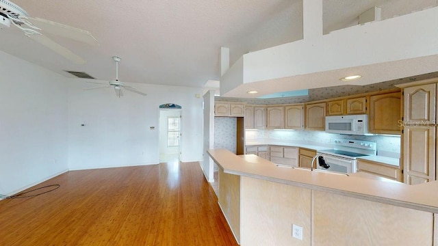 kitchen featuring backsplash, ceiling fan, white appliances, light wood-type flooring, and light brown cabinetry