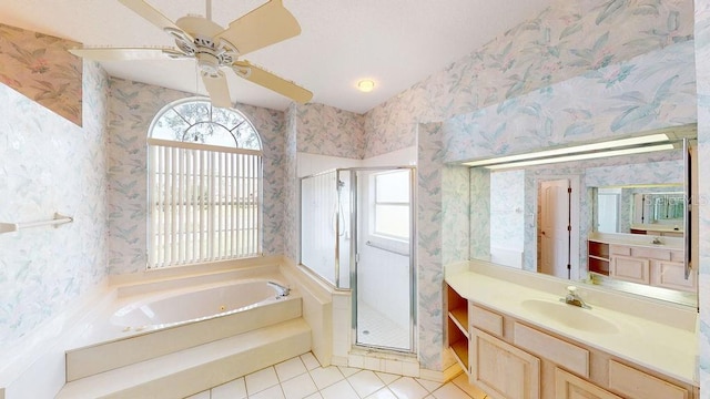 bathroom featuring independent shower and bath, vanity with extensive cabinet space, tile flooring, and ceiling fan