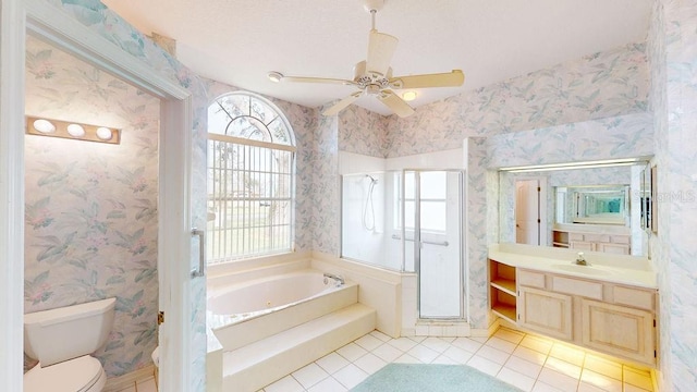 full bathroom featuring tile floors, vanity with extensive cabinet space, ceiling fan, and a wealth of natural light