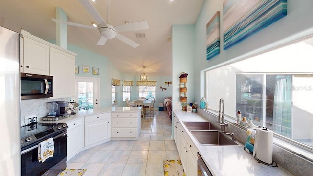 kitchen with stainless steel appliances, light tile floors, ceiling fan, backsplash, and sink