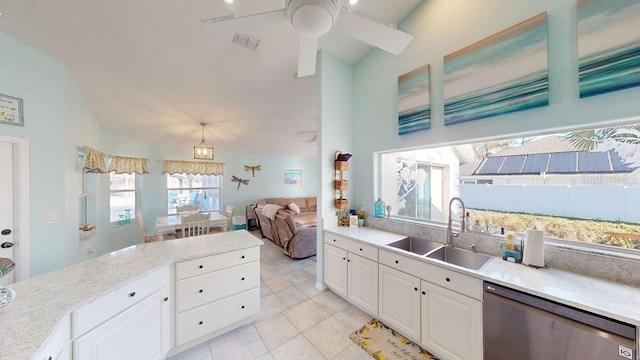 kitchen with white cabinetry, ceiling fan, sink, stainless steel dishwasher, and a wealth of natural light