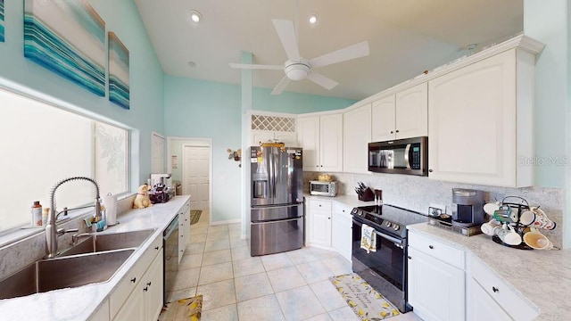 kitchen featuring stainless steel appliances, ceiling fan, tasteful backsplash, white cabinetry, and sink