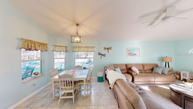 interior space with lofted ceiling and ceiling fan with notable chandelier