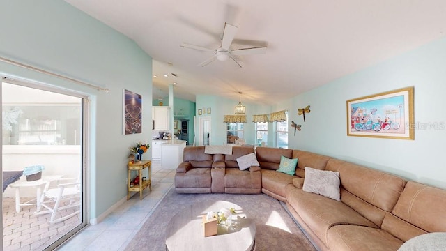 living room featuring light tile floors, lofted ceiling, and ceiling fan