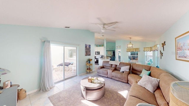 living room featuring vaulted ceiling, ceiling fan, and light tile floors