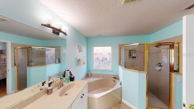 bathroom with tile floors, shower with separate bathtub, a textured ceiling, and vanity