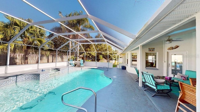 view of swimming pool with a patio area, ceiling fan, and a lanai