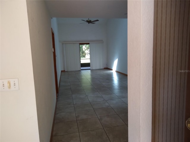 corridor with dark tile floors