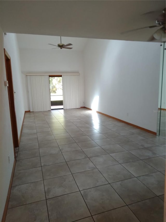 tiled empty room featuring ceiling fan