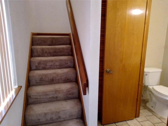 stairway with light tile floors