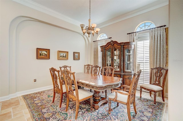 tiled dining room with an inviting chandelier and ornamental molding