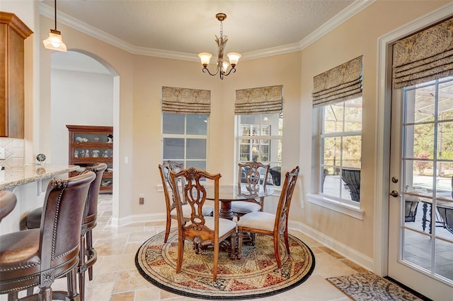 tiled dining room with a notable chandelier, a textured ceiling, and crown molding