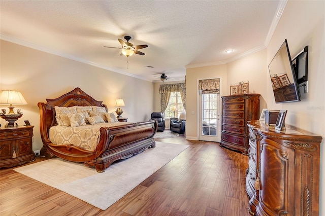 bedroom with access to exterior, ceiling fan, a textured ceiling, hardwood / wood-style flooring, and ornamental molding