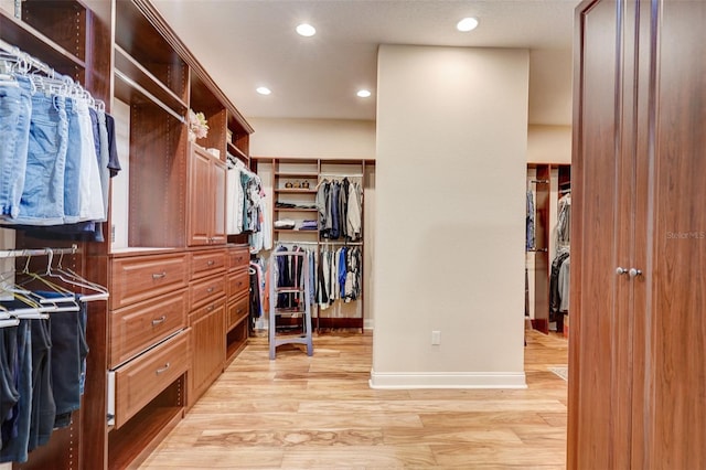 spacious closet featuring light hardwood / wood-style flooring