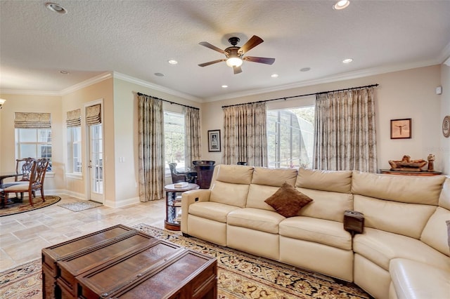 tiled living room featuring a textured ceiling, ceiling fan, and ornamental molding