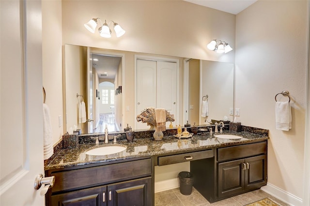 bathroom with dual vanity and tile flooring