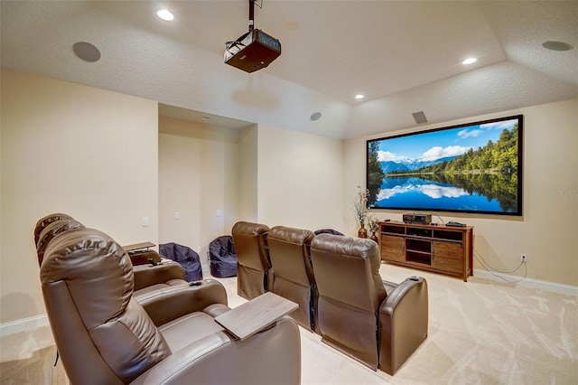 carpeted home theater with lofted ceiling and a textured ceiling