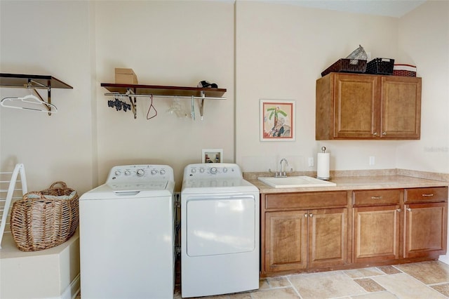 clothes washing area featuring independent washer and dryer, cabinets, light tile flooring, and sink