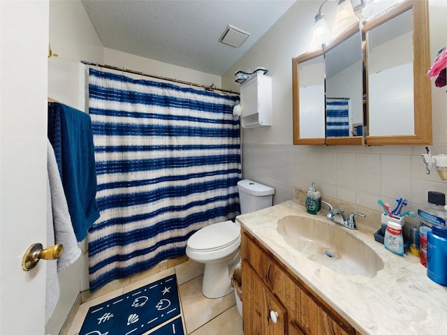 bathroom featuring tile walls, toilet, tile flooring, oversized vanity, and tasteful backsplash