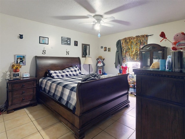 tiled bedroom featuring a textured ceiling and ceiling fan