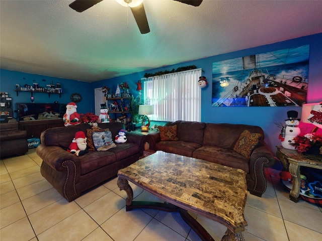 living room featuring a textured ceiling, ceiling fan, and light tile flooring