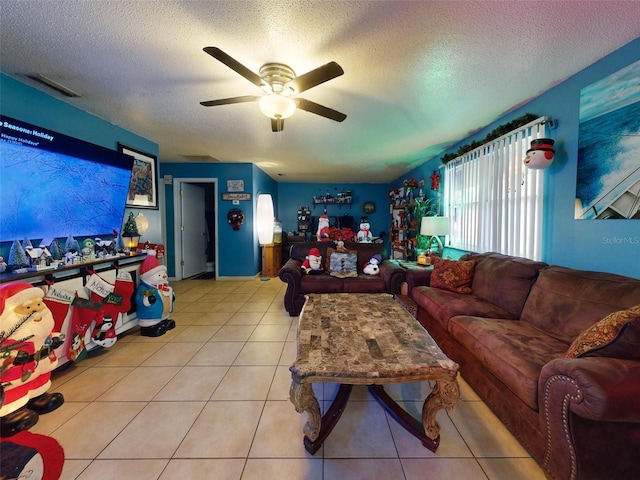 tiled living room featuring a textured ceiling and ceiling fan