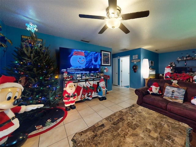 tiled living room with a textured ceiling and ceiling fan